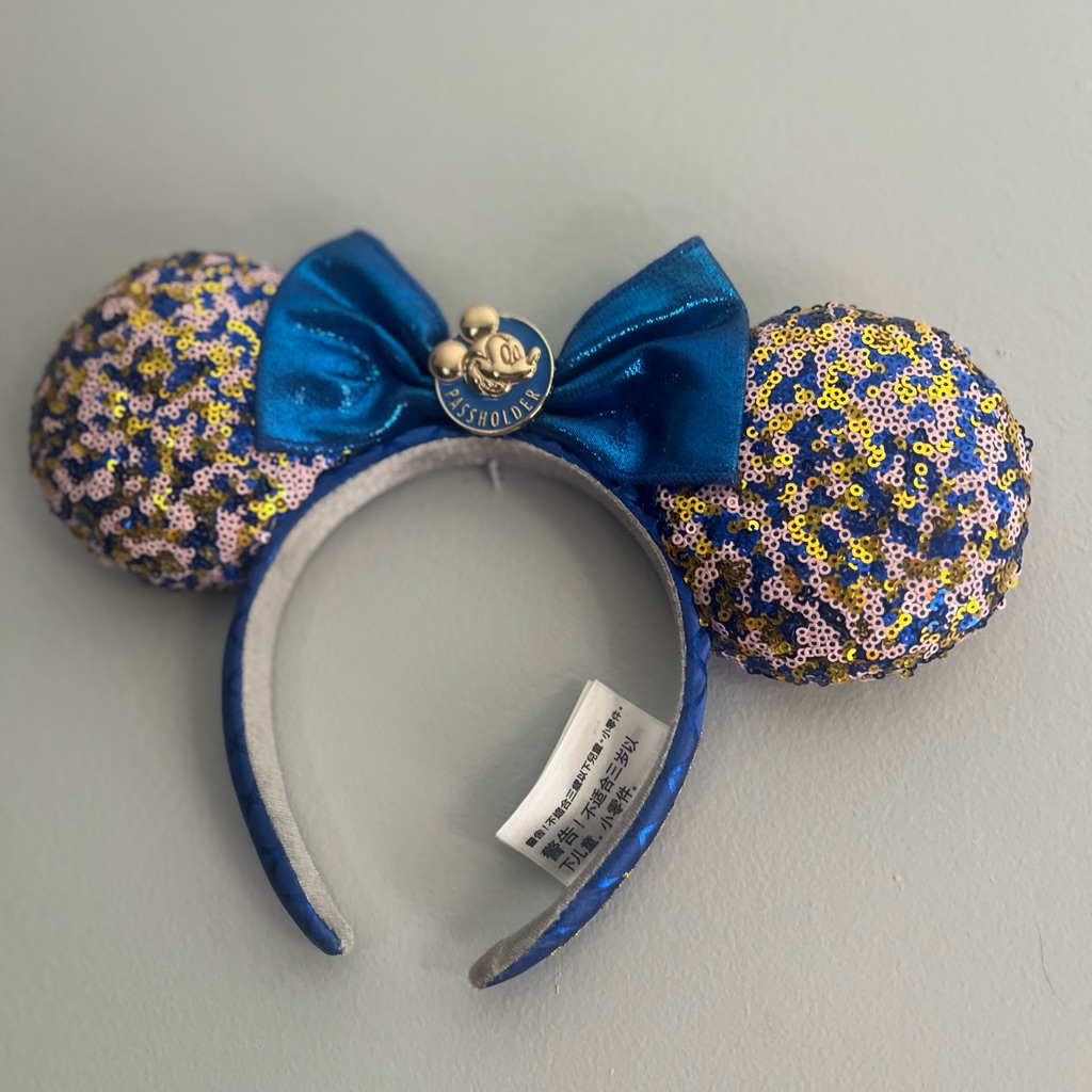 A sequin Minnie Mouse ears headband photographed for a US resale marketplace listing